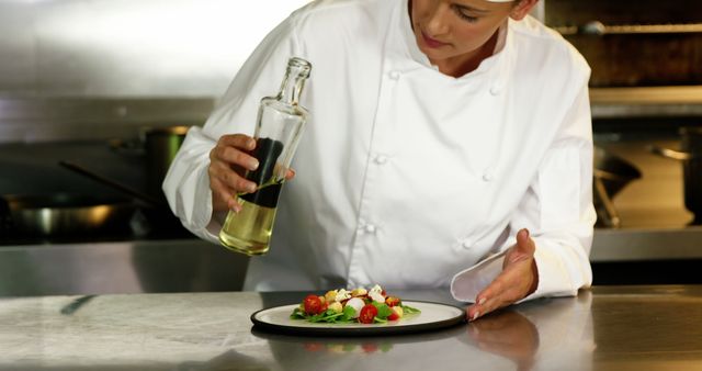 Professional Chef Drizzling Oil on Gourmet Dish in Restaurant Kitchen - Download Free Stock Images Pikwizard.com