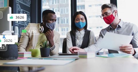 Diverse Team Collaborating in Office with Social Media Overlays