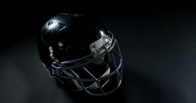 Black Football Helmet on Dark Background - Download Free Stock Photos Pikwizard.com