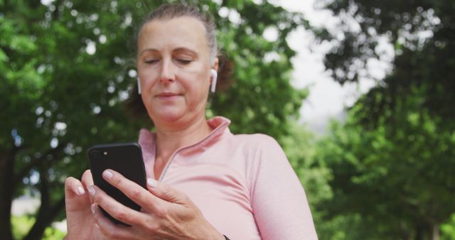 Active Middle-aged Woman Using Smartphone in Park - Download Free Stock Images Pikwizard.com