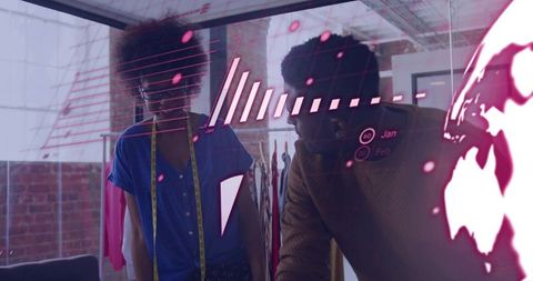 Designers Collaborating Over Holographic Data on Glass Panel in Loft Fashion Studio Using Measuring 