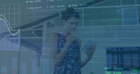 Businesswoman analyzing stock charts on tablet in modern glass atrium for data analytics