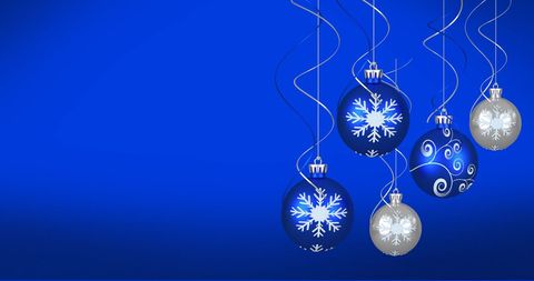 Christmas Baubles Hanging on Elegant Blue Background