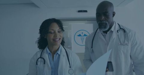 Doctors Collaborating on Diagnosis with Documents at Modern Clinic