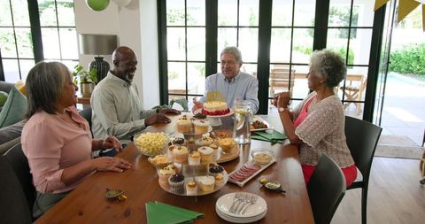Senior Friends Celebrating Birthday Gathering at Home