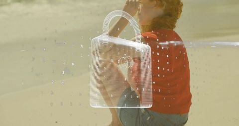 Woman gazing at sea with digital security icon