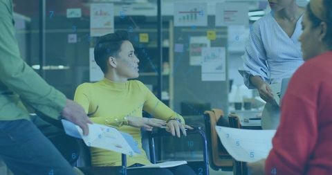 Team collaborating in modern office with woman in yellow top leading meeting discussion