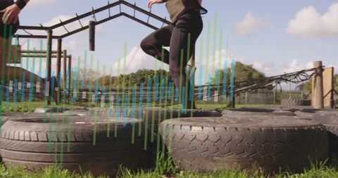 Woman navigating tire challenge on outdoor obstacle course