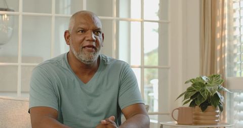 Senior Man Reflecting in Comfortable Home Setting