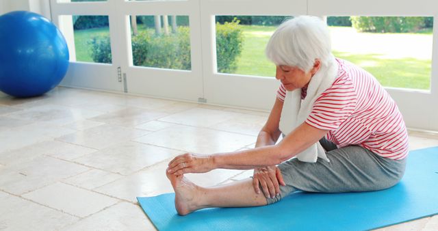 Elderly Woman Stretching on Yoga Mat in Bright Room - Download Free Stock Images Pikwizard.com