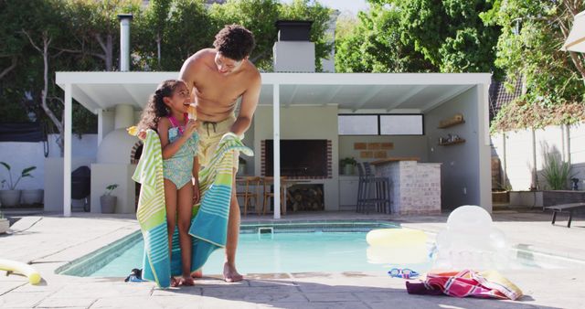 Happy biracial father and daughter spending time at pool together. domestic lifestyle, spending free time at home.