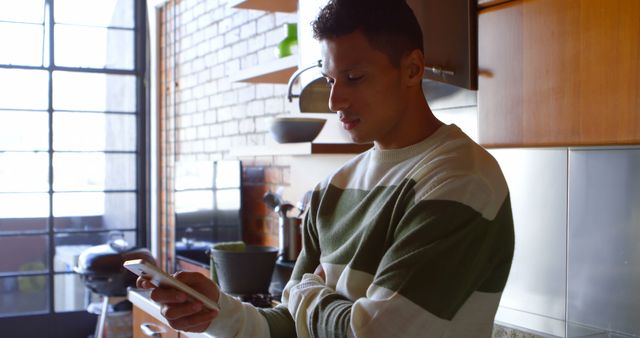 Man Checking Smartphone in Modern Kitchen - Download Free Stock Images Pikwizard.com