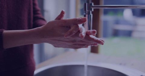 Washing hands under running water for hygiene and cleanliness