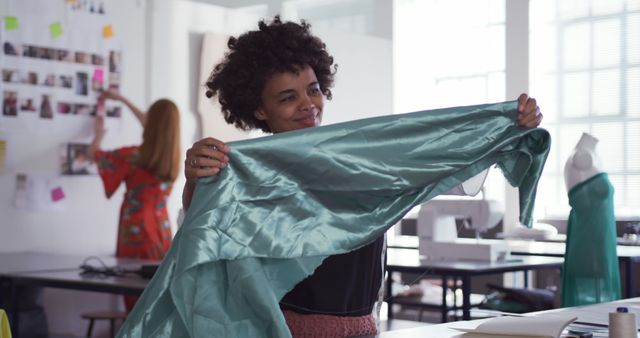 Young Fashion Designer Examining Fabric in Modern Studio - Download Free Stock Images Pikwizard.com