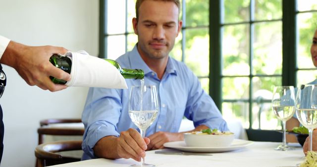 Man Dining at Upscale Restaurant Being Served Wine - Download Free Stock Images Pikwizard.com