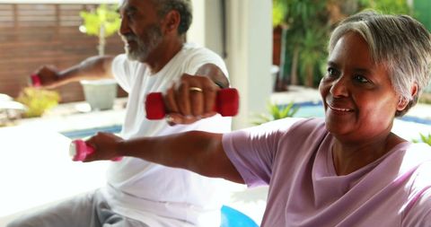 Active Senior Couple Enjoying Workout with Dumbbells in Bright Home - Download Free Stock Images Pikwizard.com