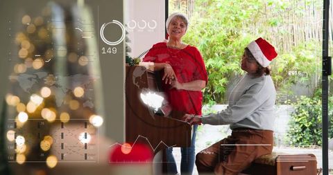 Mature women playing piano together during christmas celebration with festive hud