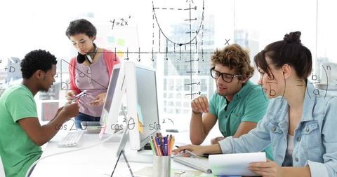 Diverse young colleagues collaborating on math equations and design at bright modern office