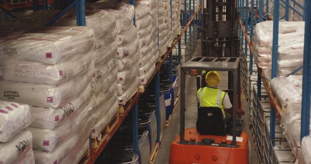 Warehouse Worker Operating Forklift Between Stacked Pallets - Download Free Stock Images Pikwizard.com