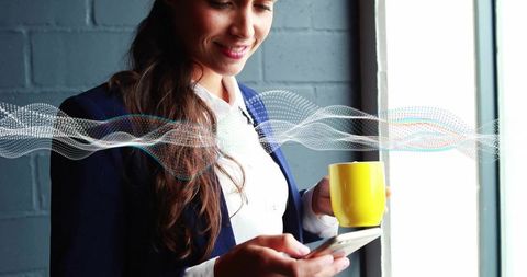 Businesswoman enjoying break with smartphone in modern office