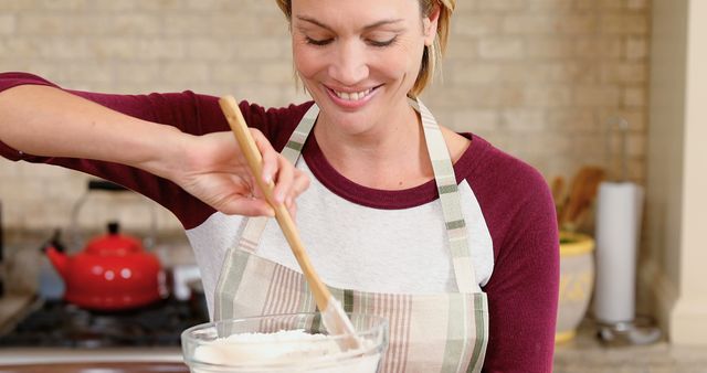 Smiling Woman Mixing Ingredients in Kitchen - Download Free Stock Images Pikwizard.com