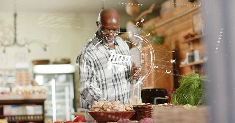 Senior grocer arranging mushrooms with augmented reality shopping cart overlay in rustic market