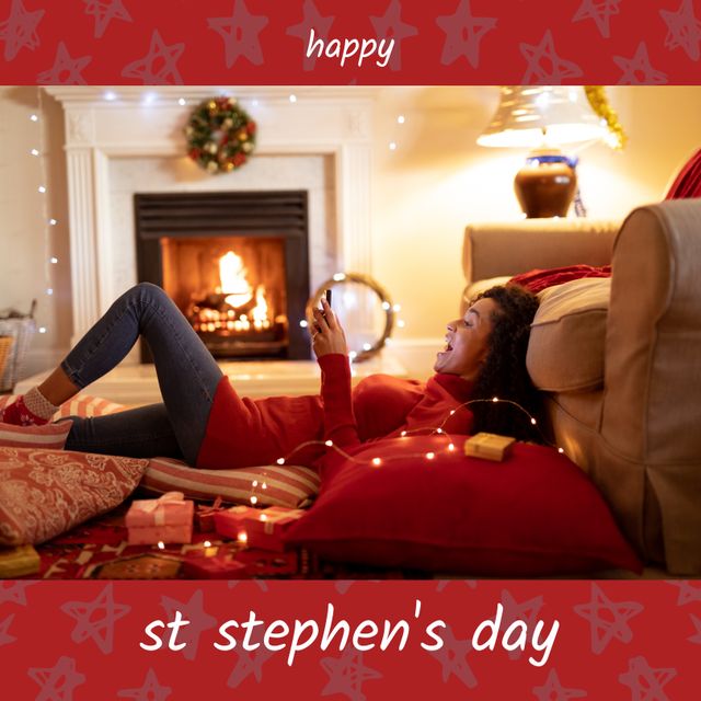 Smiling Woman by Fireplace with Smartphone on St Stephen's Day - Download Free Stock Templates Pikwizard.com