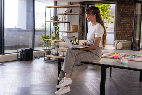 Woman Working Remotely in Modern Creative Workspace