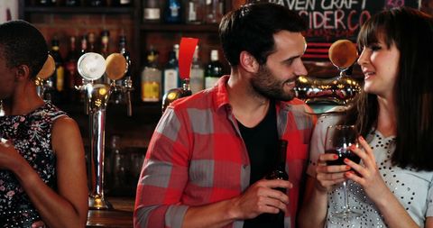 Group of Friends Socializing in a Lively Pub Atmosphere