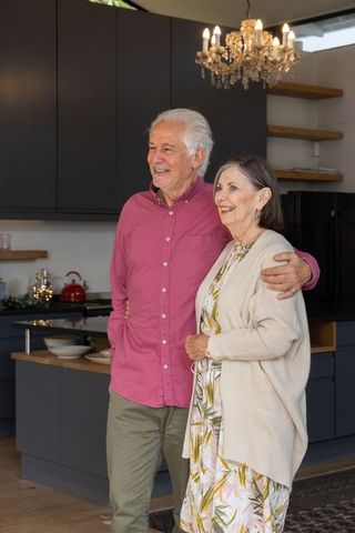 Senior Couple Smiling in Cozy and Elegant Kitchen