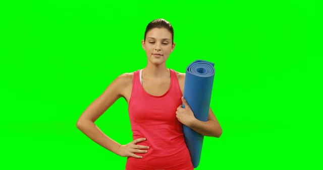 Fit woman touching invisible screen against green screen