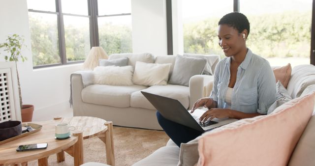 Happy Woman Working on Laptop at Home with Wireless Earbuds - Download Free Stock Images Pikwizard.com