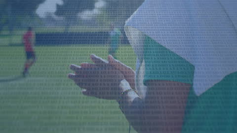 Digital Overlay Featuring Binary Code and Football Players