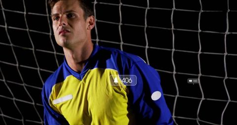 Goalkeeper in dynamic action on brightly lit field