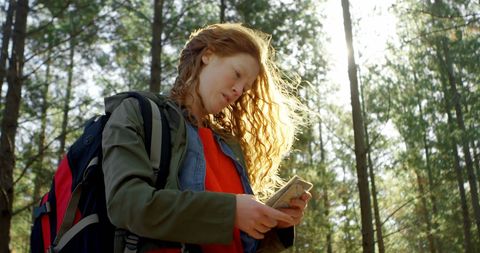 Woman Navigating Forest Path with Mobile Device - Download Free Stock Images Pikwizard.com