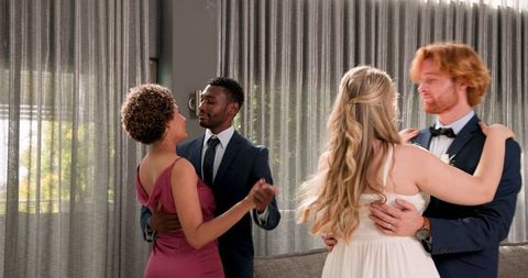Couples joyfully dancing at intimate wedding reception