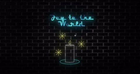 Neon Joy to the World Sign With Candle on Brick Wall