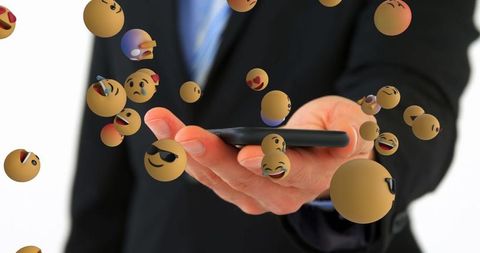 Businessman offering smartphone with floating emoji expressions