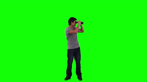 Man Using Binoculars Isolated on Green Background