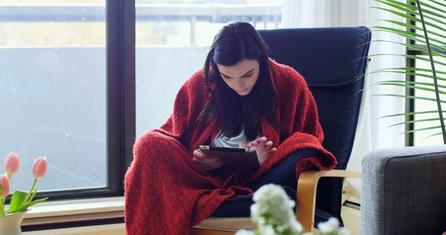 Woman in Red Blanket Reading on Digital Tablet in Cozy Living Room - Download Free Stock Images Pikwizard.com