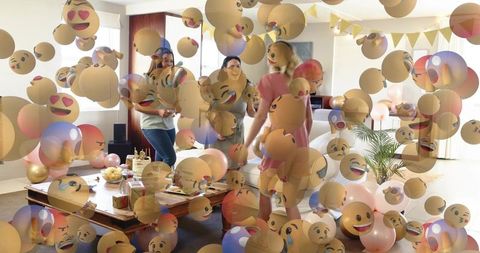 Women and baby celebrating at-home party with pastel balloons and emoji overlay decoration