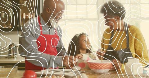 Grandparents and granddaughter baking together stirring batter with red mixing bowl