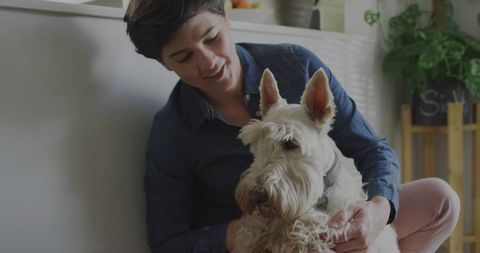 Woman Relaxing with White Terrier by Sunny Window