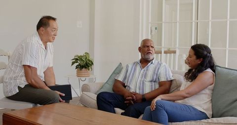 Diverse Elderly Couple Consults with Advisor on Future Planning