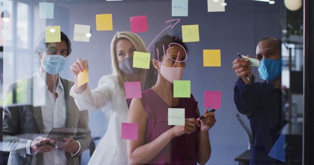 Team Brainstorming Session With Sticky Notes and Masks in Office - Download Free Stock Images Pikwizard.com