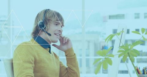 Customer service agent talking with headset at modern office desk