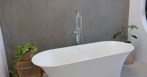 Elegant Minimalist Bathroom with Freestanding Bathtub and Natural Decor