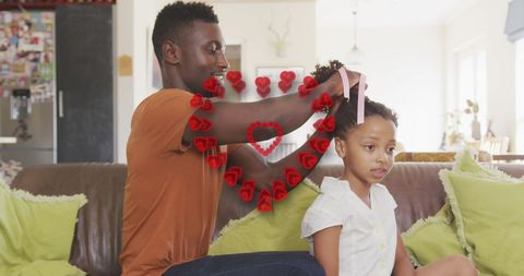 Father Braiding Daughter's Hair at Home, Family Bonding