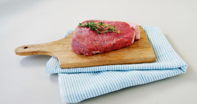 Raw Steak on Wooden Cutting Board with Fresh Herbs - Download Free Stock Images Pikwizard.com