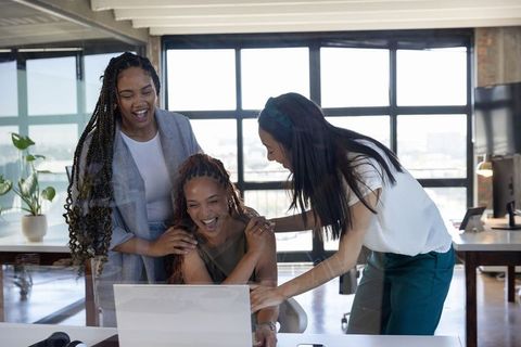 Diverse Businesswomen Collaborating on Project at Office Workspace